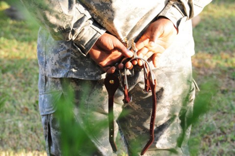 A "Spur Holder" holds a set of the coveted spurs of a Cavalry "Trooper", during the awards ceremony, Oct. 24 to 25, 2012, for the Soldiers with 1st Squadron, 61st Cavalry Regiment, 4th Brigade Combat Team, 101st Airborne Division, that qualified both mentally and physically during the Spur Ride at Fort Campbell, Ky. (U.S. Army photo by Staff Sgt. Todd A. Christopherson, 4th Brigade Combat Team Public Affairs)