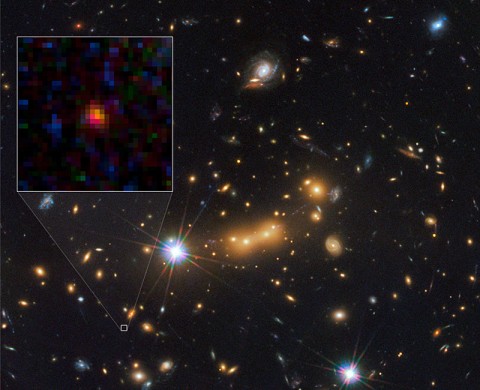 In this image, astronomers use NASA's Hubble Space Telescope and a cosmic zoom lens to uncover the farthest known galaxy in the universe. Observations from NASA's Spitzer Space Telescope helped confirm the finding. (Image credit: NASA/ESA/STScI/CLASH)