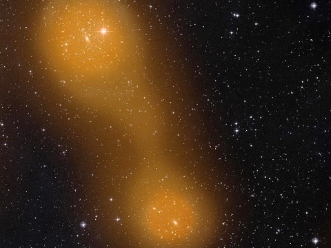 Planck has discovered a bridge of hot gas that connects galaxy clusters Abell 399 (lower center) and Abell 401 (top left). The galaxy pair is located about a billion light-years from Earth, and the gas bridge extends approximately 10 million light-years between them. (Image credits: Sunyaev-Zel'dovich effect: ESA Planck Collaboration; optical image: STScI Digitized Sky Survey)