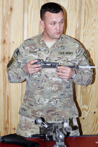 Sgt. Jason Sabin, a member of Security Force Assistance Advisory Team 6, 2nd Battalion, 327th Infantry Regiment, 1st Brigade Combat Team, 101st Airborne Division, holds the bolt carrier assembly of an M240B machine gun this week during a class on Combat Outpost Honikar-Miracle, Afghanistan.The class was given to Afghan National Army soldiers to instruct them on basic weapon skills so they could in turn teach their fellow soldiers what they learned. (U.S. Army photo by Sgt. Jon Heinrich, Task Force 1-101 PAO) Sgt. Jason Sabin, a member of Security Force Assistance Advisory Team 6, 2nd Battalion, 327th Infantry Regiment, 1st Brigade Combat Team, 101st Airborne Division, holds the bolt carrier assembly of an M240B machine gun this week during a class on Combat Outpost Honikar-Miracle, Afghanistan.The class was given to Afghan National Army soldiers to instruct them on basic weapon skills so they could in turn teach their fellow soldiers what they learned. (U.S. Army photo by Sgt. Jon Heinrich, Task Force 1-101 PAO)