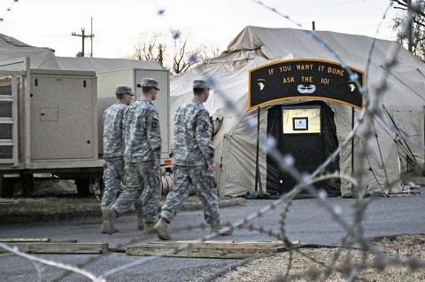 Pvt. Joshua Wagner, a fires support specialist, Sgt. Ryan Davis and Staff Sgt. Nathan Wilkinson, both fires support noncommissioned officers, all with Company A, Headquarters and Headquarters Battalion, 101st Airborne Division, make their way to an exercise fusion cell during Unified Endeavor 13-1 here Dec. 2nd. (Photo by Sgt. Grant Matthes)