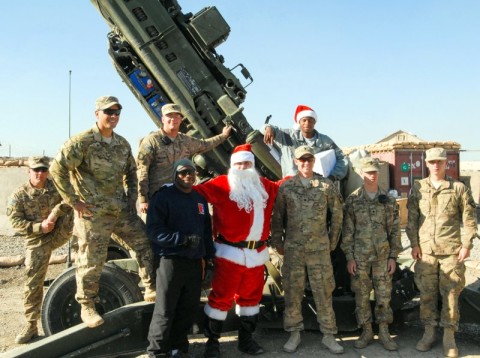 Chief Warrant Officer 2 Brian Boase, an intelligence cheif, Headquarters, Headquarters Company, 3rd Brigade Combat Team "Rakkasans," 101st Airborne Division (Air Assault), visits Soldiers from Battery A, 3rd Battalion, 320th Field Artillery Regiment,  after delivering care packages dressed Santa at Forward Operating Base Salerno, Afghanistan, Dec. 25th, 2012. Boase dressed as Santa and delivered more than 200 care packages to the Soldiers and civilians of FOB Salerno for Christmas. (U.S. Army photo by Spc. Brian Smith-Dutton, Task Force 3/101 Public Affairs)