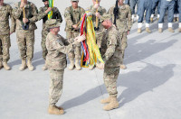 Col. J.P. McGee and Command Sgt. Maj. Thomas W. Eppler, the commander and command sergeant major of the 1st Brigade Combat Team, 101st Airborne Division, uncase the brigade colors December 5th during the Transfer of Authority ceremony from 4th BCT, 4th Infantry Division to the 201st Afghan National Army Corps here. (U.S. Army photo by Sgt. Jon Heinrich, Taskforce 1-101 PAO)