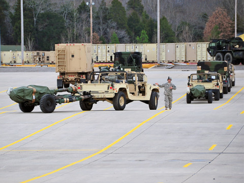 Soldiers with 4th Battalion, 320th Field Artillery Regiment, 4th Brigade Combat Team, 101st Airborne Division, move a recently inspected M998 High-Mobility Multipurpose Wheeled Vehicle with an attached M119A2 105mm howitzer into a ready-line at the Campbell Rail Operations Facility on December 4th, 2012 at Fort Campbell, KY. (U.S. Army photo by Maj. Kamil Sztalkoper, 4th Brigade Combat Team Public Affairs)