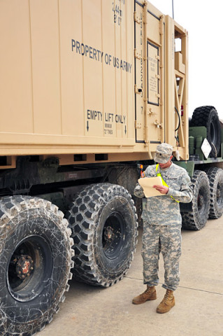 Spc. Spencer B. Olson with Bravo Battery, 4th Battalion, 320th Field Artillery Regiment, 4th Brigade Combat Team, 101st Airborne Division, checks the mechanical inspection data on a Heavy Expanded Mobility Tactical Truck, Palletized Load System during the 4th Brigade's rail-operations inspection station on December 4th, 2012 at Fort Campbell, KY. (U.S. Army photo by Maj. Kamil Sztalkoper, 4th Brigade Combat Team Public Affairs)