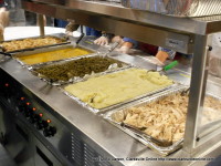 Traditional Christmas meal consisting of turkey and dressing, mashed potatoes, green beans, rolls and tables of desserts was served.