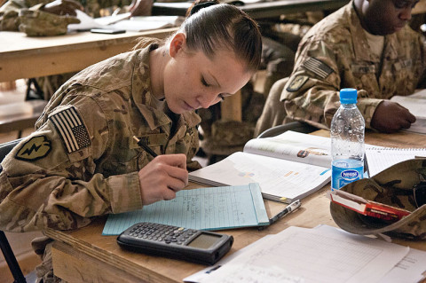 Spc. Amber Eddy, Headquarters and Headquarters company, 5th Battalion, 158th Aviation, aviation operations specialist, a native of Brigham City, Utah, takes notes and attempts to solve a problem posed to the the students during a class covering probability and statistics in a Task Force Ready classroom in Balkh province, Afghanistan, Nov. 14th. (U.S. Army photo by Sgt. Duncan Brennan, 101st CAB public affairs)