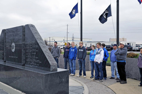 Members of the Friendship Christian Reform Church pay their respects at the Night Stalker monument during a visit to the General Brown compound December 7th at Fort Campbell, KY. The Night Stalker monument serves as a tribute to the 91 fallen Night Stalkers, who paid the ultimate sacrifice for the cause for freedom. (160th SOAR (A)courtesy photo)