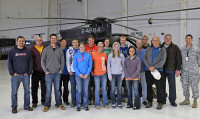 Members of the Friendship Christian Reform Church capture a memory of their visit in front of an AH-6M Little Bird helicopter during a visit to the General Brown compound December 7th. at Fort Campbell, KY. (160th SOAR (A) courtesy photo)