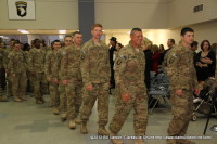 The soldiers heading to go turn in their weapons, so they can be released to the families.