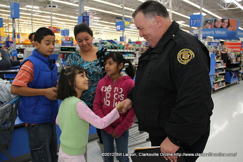 A young lady thanks Officer Tyler Barrett for everything the police union did for her and her family during Shop with a Cop.