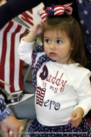 A little girl waits for her Daddy to arrive