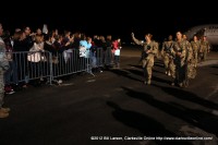 Soldiers head towards the terminal past their waiting families