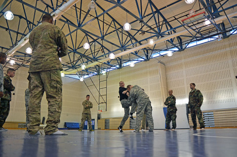 Sgt. 1st Class Christopher Fulbright, a combatives level one class instructor with the 7th Squadron, 17th Cavalry Regiment, (left) shows his students how to properly knee their opponent during a combatives level one course Dec. 12th at Fort Campbell, KY. (U.S. Army photo by Sgt. Shanika L. Futrell, 159th Combat Aviation Brigade Public Affairs)