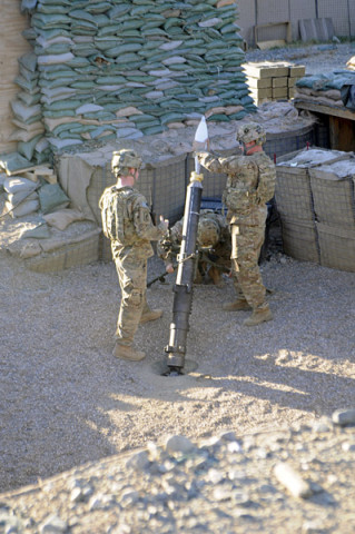 Staff Sgt. Christopher Dollar, a native of Yakima, Wash., loads a 120mm illumination mortar round during outgoing fire training Dec. 2, 2012, at FOB Joyce, Afghanistan. Dollar is a gunnery sergeant with Battery A, 2nd Battalion, 320th Field Artillery Regiment, 1st Brigade Combat Team, 101st Airborne Division, and is currently a mortar crew member with 2nd Battalion, 327th Infantry Regiment, 1st BCT at Joyce. (U.S. Army photo by Sgt. Jon Heinrich, Task Force 1-101 PAO)