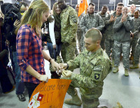 First Lt. Mathew Miller places an engagement ring on the finger of his girlfriend, Caitlain Stein, moments after returning from his deployment to Afghanistan during a welcome home ceremony, Dec. 13, at Fort Campbell.  (U.S. Army Photo)