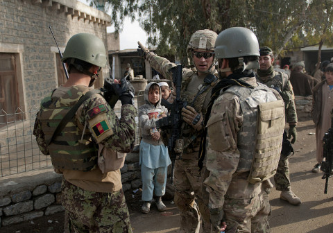 U.S Army Sgt. 1st Class Anthony Greene, the platoon sergeant for 2nd Platoon, Company B, 3rd Battalion, 187th Infantry Regiment, 3rd Brigade “Rakkasans,” 101st Airborne Division (Air Assault), shows his Afghan National Army counterpart where his troops are during a patrol through a bazaar in Khowst Province, Afghanistan, Jan. 11, 2013. The patrol was conducted to enroll local Afghans into the Secure Electronic Enrollment Kit. (Spc. Alex Kirk Amen/U.S. Army)