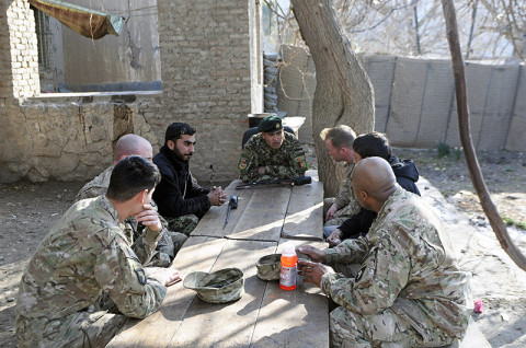 U.S. Army soldiers from 1st Brigade Combat Team, 101st Airborne Division, sit with their Afghan National Army artillery counterparts from 2nd Brigade, 201st Corps Jan. 18th, 2013, to discuss and evaluate the day’s live fire exercise at Combat Outpost Monti, Afghanistan. (U.S. Army photo by Sgt. Jon Heinrich, Task Force 1-101 PAO)