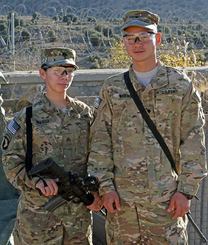 U.S. Army Sgt. Lizeth Wakasa (left), a food service specialist assigned to Headquarters Company, 3rd Battalion, 187th Infantry Regiment, 3rd Brigade Combat Team “Rakkasans,” 101st Airborne Division (Air Assault), stands proudly by her husband U.S. Army Spc. David Wakasa (right), also a food service specialist with Headquarters, 3-187, at Combat Outpost Bowri Tana, Dec. 1st, 2012. (U.S. Army photo by Sgt. 1st Class Abram Pinnington, Task Force 3/101 Public Affairs)