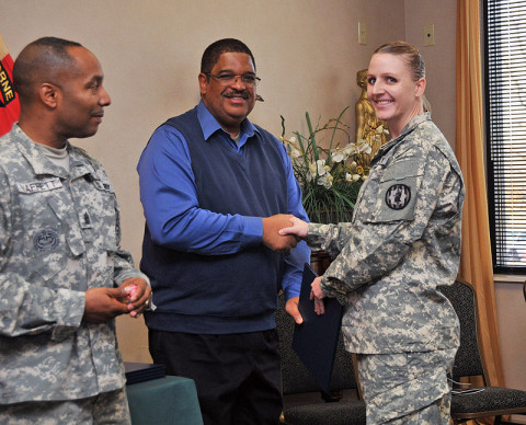 Spc. Rebekkah G. Young a human resource specialist assigned to 716th Military Police Battalion, 101st Sustainment Brigade "LifeLiners" receives a diploma from Hayward C. Seymore, a civilian postal instructor with Interservice Postal Training Activity from Fort Jackson, SC, during Postal Operations course graduation at Fort Campbell, KY, Dec. 14th, 2012. The Postal Operations course trains the soldiers on how to operate a post office while deployed or overseas. (Photo by Sgt. Sinthia Rosario)