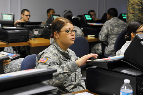 Spc. Mayra I. Ruiz Herrera, a human resource specialist with 3rd Platoon, 101st Human Resource Company, 101st Sustainment Brigade "LifeLiners," types on the Intergrated Retail Terminal machine during a Postal Operations course at Fort Campbell, KY, Dec. 12th, 2012. The Postal Operations course trains the soldiers on how to operate a post office while deployed or overseas. (Photo by Sgt. Sinthia Rosario)