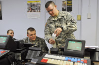 Spc. Nathaniel W. Harp, a human resource specialist with 2nd Platoon, 101st Human Resource Company, 101st Sustainment Brigade “LifeLiners,” inserts receipt paper into the Intergrated Retail Terminal machine during a Postal Operations course at Fort Campbell, KY, Dec. 12th, 2012. The Postal Operations course trains the soldiers on how to operate a post office while deployed or overseas. (Photo by Sgt. Sinthia Rosario)