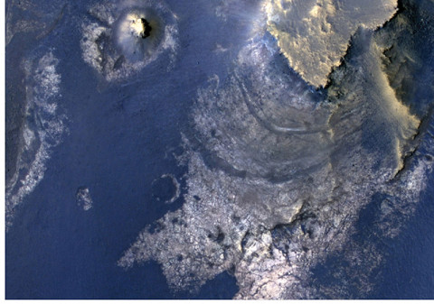 This view of layered rocks on the floor of McLaughlin Crater shows sedimentary rocks that contain spectroscopic evidence for minerals formed through interaction with water. The High Resolution Imaging Science Experiment (HiRISE) camera on NASA's Mars Reconnaissance Orbiter recorded the image. (Image Credit: NASA/JPL-Caltech/Univ. of Arizona)