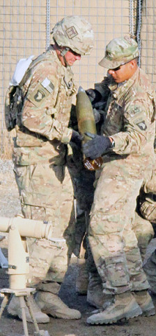 U.S. Army Spc. Taylor Barnes (left), a native of Canandaigua, N.Y., is an artilleryman assigned to Battery B, 3rd Battalion, 320th Field Artillery Regiment, 3rd Brigade Combat Team “Rakkasans,” 101st Airborne Division (Air Assault), receives ammunition for a fire mission at Camp Clark, Afghanistan, Jan. 14th, 2013. (U.S. Army photo by Spc. Brian Smith-Dutton, TF 3/101 Public Affairs)