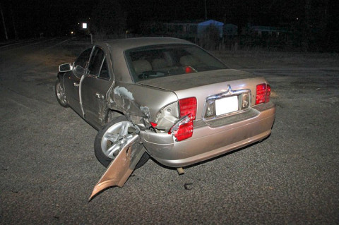 2000 Lincoln LS rolled through a stop sign and in front of the oncoming 2006 Mitsubishi Galant. The Galant hit the Lincoln behind the driver's side rear tire area.