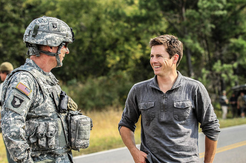 Maj. Gen. James C. McConville, commanding general of the 101st Airborne Division (Air Assault) and Fort Campbell, Ky., shares a laugh with Tanner Foust, stunt driver and the host of Top Gear, during a break in shooting while filming an episode for the History Channel show at a Fort Campbell training area, Sept. 26. Foust challenged being captured by the 101st and its assets during a "cat and mouse" chase scenario and was impressed with the skills of the 101st units and their top gear.  (U.S. Army photo by Sgt. Joe Padula, 2nd BCT PAO, 101st Abn. Div.)