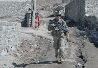 Afghan Children watch U.S. Army Sgt. Jason Finamore, a team leader with 3rd Platoon, A Troop, 1st Squadron, 33rd Cavalry Regiment, 3rd Brigade, 101st Airborne Division (Air Assault), as he moves through a village, Feb. 12, 2013, in Paktya Province, Afghanistan. The platoon conducted a joint patrol with the Afghan Uniformed Police. (U.S. Army photo by Spc. Alex Kirk Amen, 115th Mobile Public Affairs Detachment)
