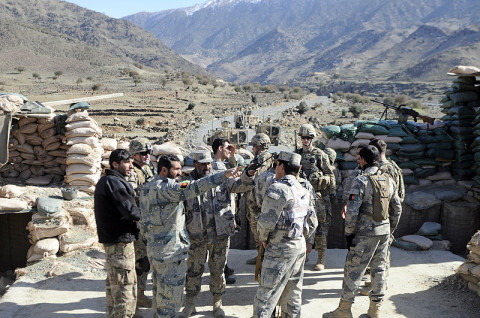Afghan Border Police and U.S. Army Soldiers from 2/1 ABP, 2nd Battalion, 327th Infantry Regiment, 1st Brigade Combat Team, 101st Airborne Division, stand on the roof of an observation post outside Forward Operating Base Joyce, Afghanistan, Jan. 28th, 2013, discussing operations the ABP have in the area. (U.S. Army photo by Sgt. Jon Heinrich, Task Force 1-101 PAO)