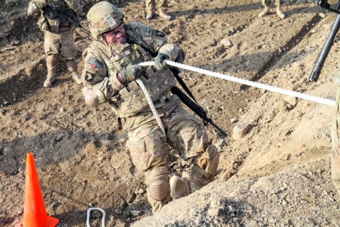 Spc. James Craig, an air defense battle management system operator assigned to Headquarters, Headquarters Company, 3rd Brigade Combat Team “Rakkasans,” 101st Airborne Division (Air Assault), uses a rope to pull himself over a large dirt wall in the obstacle course portion of the brigade noncommissioned officer and Soldier of the quarter competition on Forward Operating Base Salerno, Afghanistan, Feb. 15, 2013. The competition included a five-mile march and five different combat related stations throughout the competition. (U.S. Army photo by Spc. Brian Smith-Dutton, Task Force 3/101 Public Affairs) 