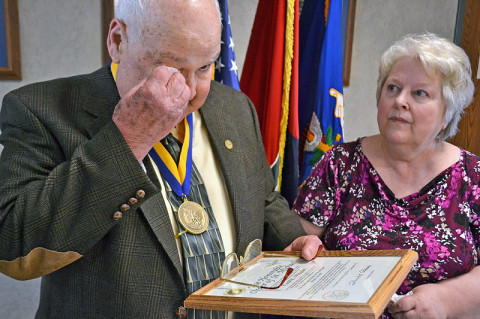 Retired Platoon Sgt. Cecil Wiggins expresses emotional gratitude as his wife, Gwen, looks on after receiving the Order of St. Michael Bronze Award during a ceremony here Feb. 22. The award lauds the leadership skills he used to turn around the production and morale of the 507th Transportation Company Detachment, attached to the “Condors,” Company C, 2nd Squadron, 17th Cavalry Regiment, 101st Airborne Division, during the Vietnam War. (U.S. Army photo by Spc. Jennifer Andersson, 159th Combat Aviation Brigade Public Affairs)