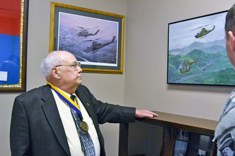 Platoon Sgt. Cecil Wiggins, retired, reminisces as he tours the 2nd Squadron, 17th Cavalry Regiment, memorabilia collection after receiving the Order of St. Michael Bronze Award during a ceremony here, Feb. 22. Wiggins, a member of the 507th Transportation Company Detachment, attached to the “Condors,” Company C, 2nd Sqdn., 17th Cav. Regt., during the Vietnam War, used his skills as a leader to boost both morale and production of the unit. (U.S. Army photo by Spc. Jennifer Andersson, 159th Combat Aviation Brigade Public Affairs)