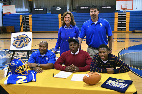 Clarksville Academy senior John Anderson, family, football coach Todd Hood and Head of School Kay Drew.