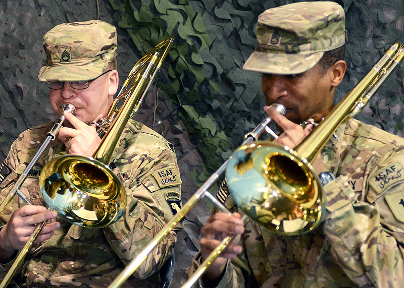U.S. Army Staff Sgt. Vincent Lawyer (left), a trombone player with the 101st Airborne Division (Air Assault) Band, and Sgt. 1st Class David McDonald, also a trombone player with the 1st Infantry Division Band, perform during the casing ceremony for the division headquarters battalion of the 1st Infantry Division and the uncasing ceremony for the division headquarters battalion for the incoming 101st Airborne Division (Air Assault), Feb. 28, 2013, at Bagram Airfield, Afghanistan. (U.S. Army photo by Sgt. 1st Class Kevin Hartman, 115th Mobile Public Affairs)