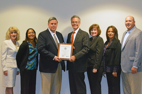 (from left) Deneen Clayton and Shinika Jenkins, and Don Harris, GRH Housing program director, DeWayne Olive, executive vice president and chief financial officer; Denise Alexander, Yvonne Witzler, and Rodney Wilds.