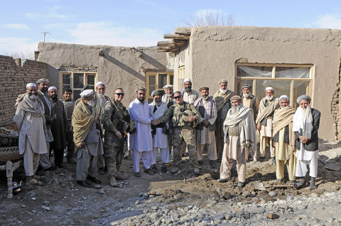 U.S. Army Staff Sgt. Vincent Garza, a squad leader with 1st Platoon, Company B, 1st Battalion, 327th Infantry Regiment, 1st Brigade Combat Team, 101st Airborne Division, and native to San Antonio, Texas, and U.S. Army Sgt. Timothy Turner, a forward observer with 1st Plt., Co. B, 1st Bn., 327th Inf. Regt., pose with village elders March 1st, 2013, outside Forward Operating Base Finley-Shields, Afghanistan. (U.S. Army photo by Sgt. Jon Heinrich, Task Force 1-101 PAO)