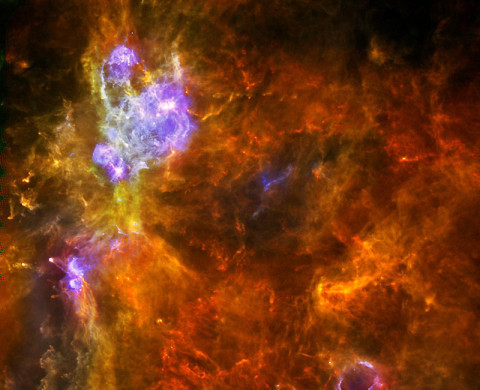 W3 is an enormous stellar nursery about 6,200 light-years away in the Perseus Arm, one of the Milky Way galaxy's main spiral arms, which hosts both low- and high-mass star formation. In this image from the Herschel space observatory, the low-mass forming stars are seen as tiny yellow dots embedded in cool red filaments, while the highest-mass stars -- with greater than eight times the mass of our sun -- emit intense radiation, heating up the gas and dust around them and appearing here in blue. (Image credits: ESA/PACS & SPIRE consortia, A. Rivera-Ingraham & P.G. Martin, Univ. Toronto, HOBYS Key Programme (F. Motte))