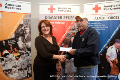 David Kirkland, the President of Local 3180 presents Julie Campos, the director of the Two Rivers Chapter of the American Red Cross with a check for $500.00.q