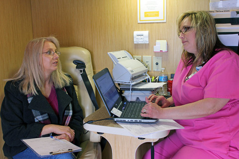 Sandra Davis (left) gets help filling out her paperwork from Laura Patterson (right), Mamographer with St. Thomas Mammography.