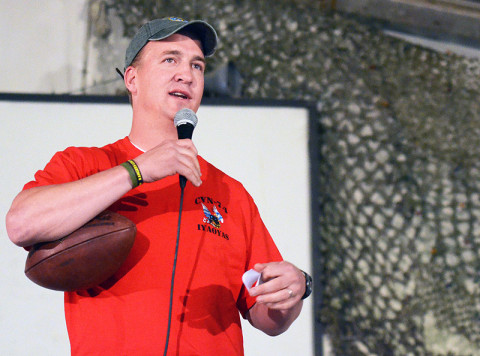 Denver Broncos’ Peyton Manning addresses the troops at Bagram Airfield, Afghanistan, with a USO tour. Manning was accompanied by MLB pitcher Curt Schilling and NFL players Austin Collie and Vincent Jackson, March 1st, 2013. (U.S. Army photo by Staff Sgt. David J. Overson 115th Mobile Public Affairs Detachment)