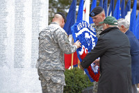 From left to right: Maj. John Page and 1st Sgt. Jeremy Clark, the Rear-Detachment Command Group of the 3rd Brigade Combat Team “Rakkasans,” 101st Airborne Division (Air Assault), Irving Weinsoff, president of the 187th National Rakkasan Association, and retired Command Sgt. Maj. James Musgrove, former regimental command sergeant major, carry the 187th Infantry Regimental Crest and place it in front of the Regimental Pylon at an activation ceremony Feb. 20 at Fort Campbell, KY. (U.S. Army photo taken by Sgt. Alan Graziano, 3rd Brigade Combat Team, 101st Airborne Division)