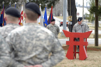 Maj. John Page, Rear-Detachment commander of the 3rd Brigade Combat Team “Rakkasans,” 101st Airborne Division (Air Assault), speaks about the long and valorous history of the 187th Infantry Regiment during an activation ceremony Feb. 20 at Fort Campbell, Ky. All of the fallen Rakkasans, whose names are inscribed on the pylons that stand in front of them. (U.S. Army photo taken by Sgt. Alan Graziano, 3rd Brigade Combat Team, 101st Airborne Division)