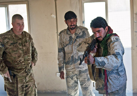 U.S. Army Sgt. First Class Frederick Robinson, with Security Transition Team, 3rd Brigade “Rakkasans,” 101st Airborne Division (Air Assault), and Afghan Border Police Sgt. Noor Ulmah, trains new police officers in basic rifle marksmanship and weapons maintenance March 2, 2013, at Combat Outpost Bowri Tana. The STT trained Ulmah in a train the trainer program. (U.S. Army Photo by Spc. Alex Kirk Amen, 115th Mobile Public Affairs Detachment)