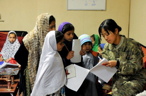 U.S. Army Spc. Gamei Kwong, 414th Civil Affairs Battalion, teaches Afghan children English.