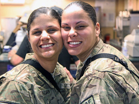 Army Spc. Janice Pagan (left), an automated logistical specialist assigned to Forward Support Company, 1st Battalion, 187th Infantry Regiment, 3rd Brigade Combat Team "Rakkasans," 101st Airborne Division (Air Assault), with her twin sister Army Spc. Janet Pagan (right), a unit supply specialist assigned to 72nd Expeditionary Signal Battalion, pose for a photo at Bagram Air Field, Afghanistan, March 17, 2013. (U.S. Army photo by Spc. Brian Smith-Dutton TF 3/101 Public Affairs)