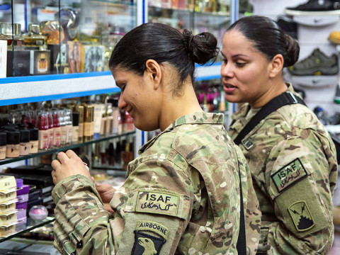 Army Spc. Janice Pagan (left), an automated logistical specialist assigned to Forward Support Company, 1st Battalion, 187th Infantry Regiment, 3rd Brigade Combat Team "Rakkasans," 101st Airborne Division (Air Assault), and her twin sister Army Spc. Janet Pagan (right), a unit supply specialist assigned to 72nd Expeditionary Signal Battalion, shop for perfume together at Bagram Air Field, Afghanistan, March 17, 2013. (U.S. Army photo by Spc. Brian Smith-Dutton TF 3/101 Public Affairs)
