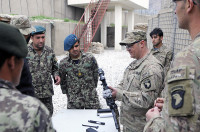 U.S. Army Sgt. 1st Class Chad Clark, the noncommissioned officer in charge of Security Forces Advisory and Assistance Team Phalanx, 1st Brigade Combat Team, 101st Airborne Division, teach Afghan National Army soldiers from 4th Combat Support Kandak, 2nd Brigade, 201st Corp, on weapons handling, March 12, 2013, at Combat Outpost Fortress, Kunar province, Afghanistan. (Photo by Sgt. Jon Heinrich)